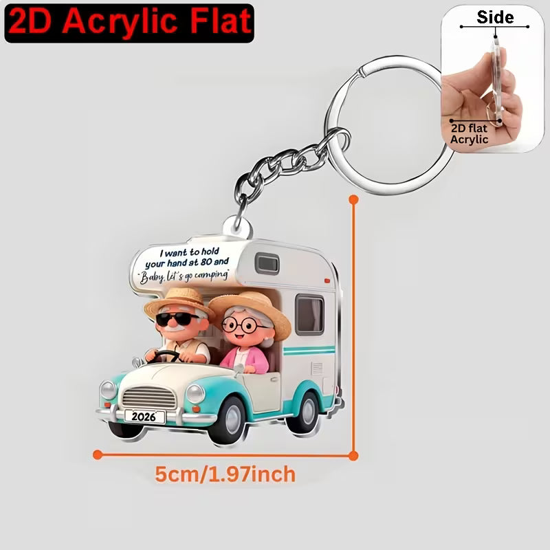 Camping couple 2D keyring with their motorhome in 2 colour options.
