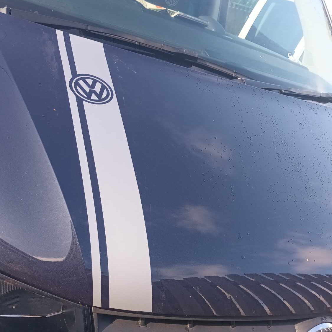 Close-up of a Volkswagen car with a white stripe on the hood.