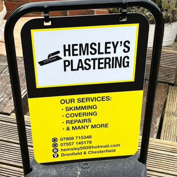Hemsley's Plastering Aboard on a stand outdoors by trailblazersbrandingco