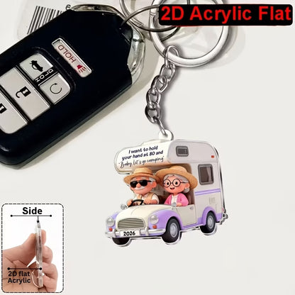 Camping couple 2D keyring with their motorhome in 2 colour options.